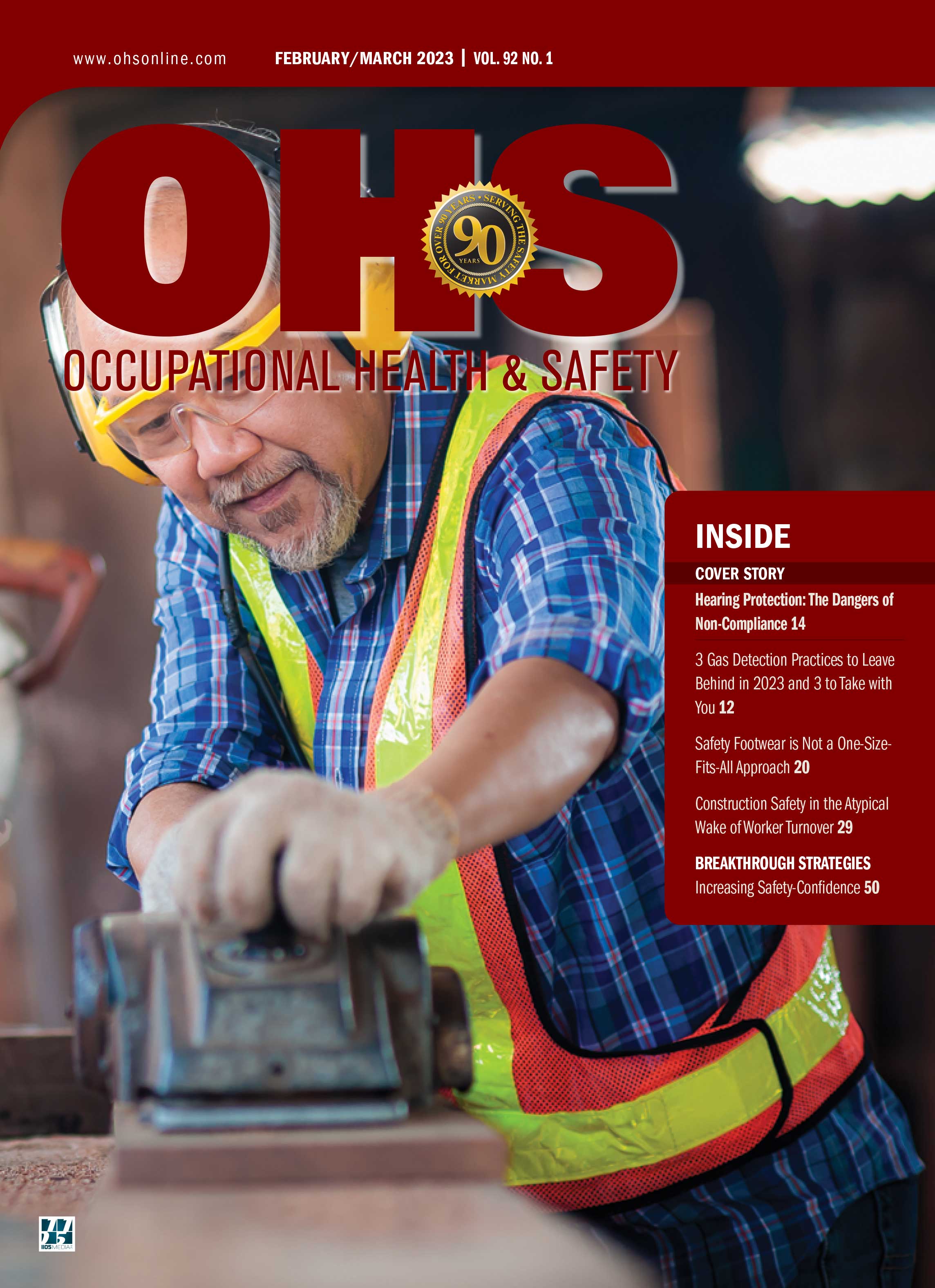 magazine cover of man in blue checkered shirt with yellow and orange vest wearing hearing, eye and hand protection while sanding object
