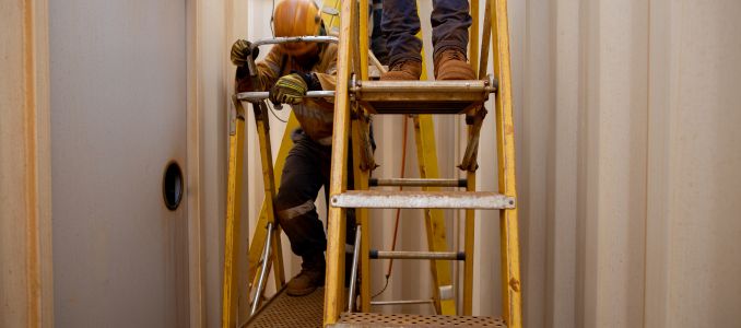 Construction Workers on Ladders