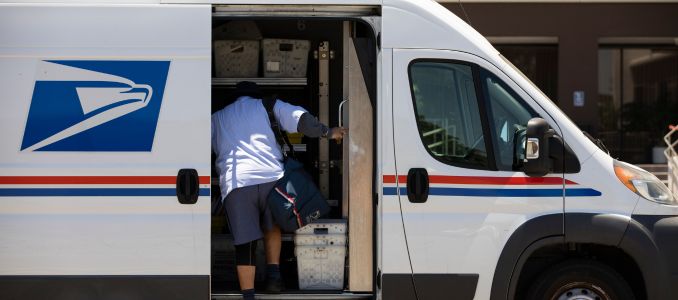 USPS Worker Climbing in Van