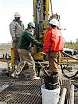 workers are shown on an active oil rig