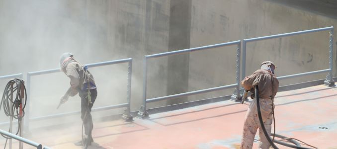 Workers Sandblasting a Roof