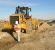 Although high-speed trucks, scrapers, and other heavy equipment can be a danger, equally dangerous is low-speed equipment backing up. (Photo courtesy of The HNTB Companies)