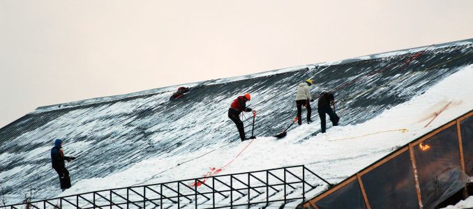 Workers Clear Snow Off a Roof